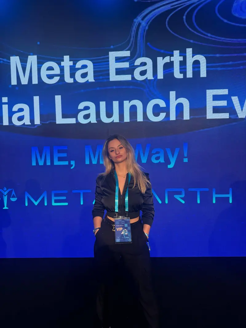 Jana at Meta Earth VIP launch with dramatic blue backdrop
